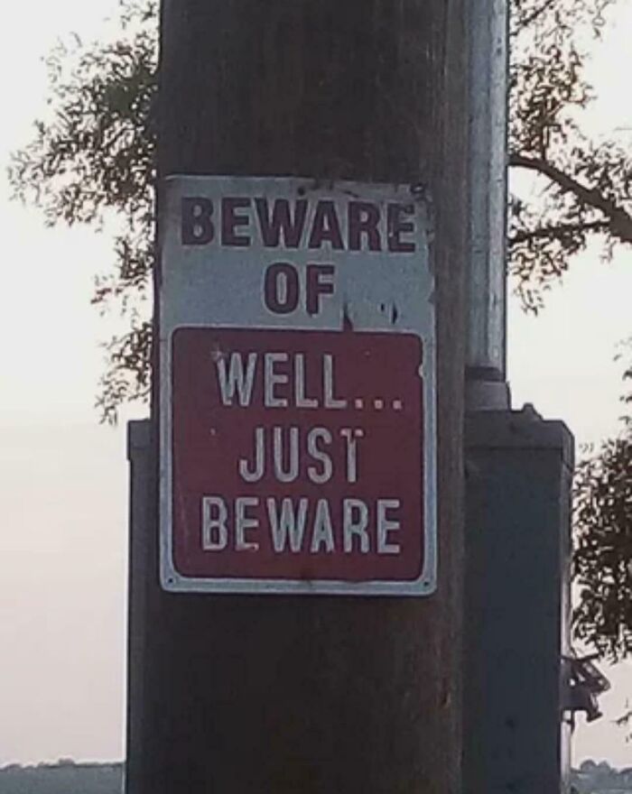 Funny beware sign saying well just beware on a pole