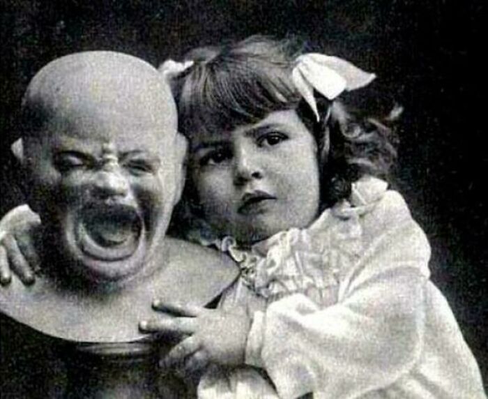 A Young Girl With A Strange Doll