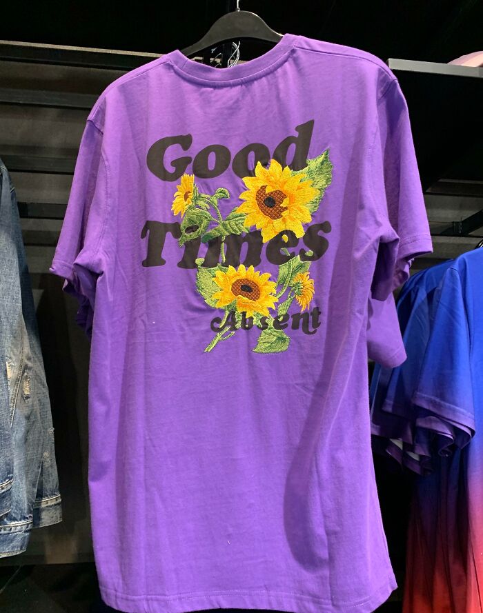 A purple T-shirt with sunflowers and the text Good Times Absent, showcasing bad clothing designs.