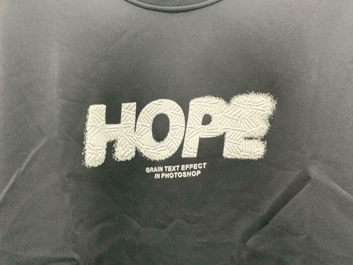 A dark gray clothing design with the word 'Hope' in white and 'Grain text effect in Photoshop' below it, representing bad clothing designs.
