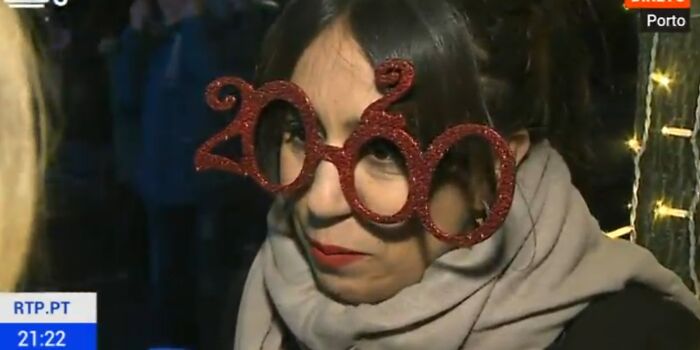 Woman wearing oversized 2000s novelty glasses, an example of bad clothing designs.