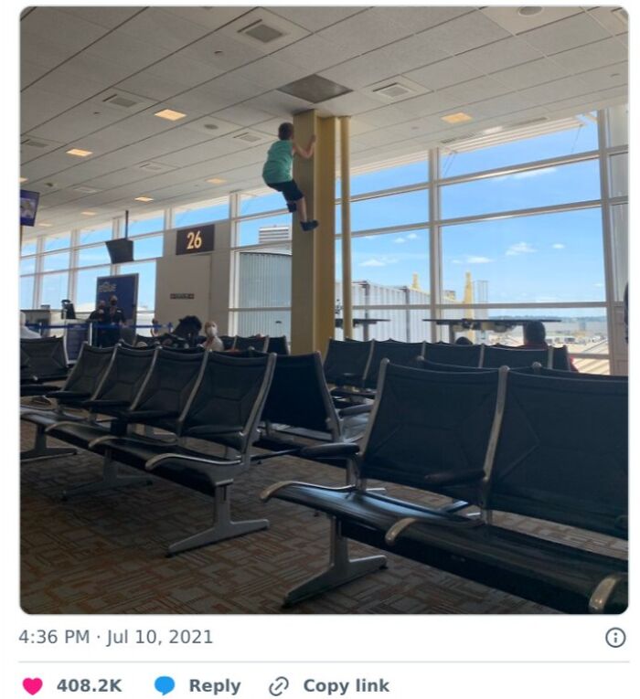 A young boy climbs a pole in an empty airport waiting area, showcasing the chaotic place.