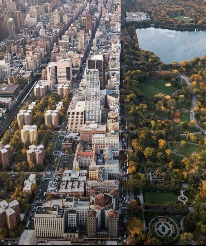 Urban hell aerial view of dense city buildings next to a large green park