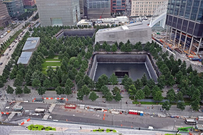 Urban memorial park surrounded by city buildings showing urban hell