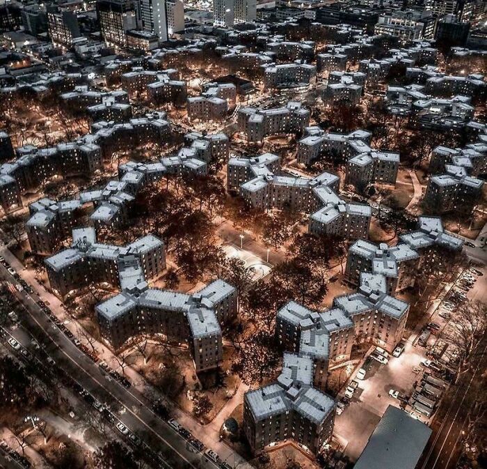 Aerial view of crowded apartment buildings at night in urban hell