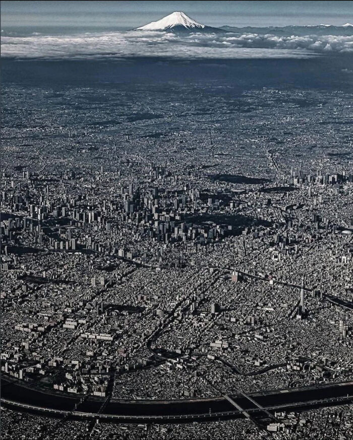 Aerial view of dense urban cityscape with Mount Fuji in background urban hell