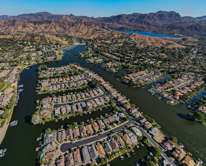 Aerial view of a crowded suburban neighborhood with water canals in urban hell