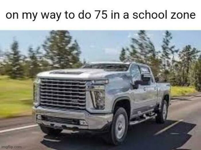 Silver pickup truck driving fast with humor about speeding in school zone suburban hell