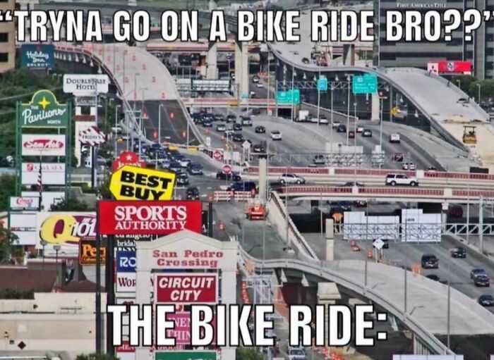 Crowded urban freeway with billboards illustrating suburban hell traffic