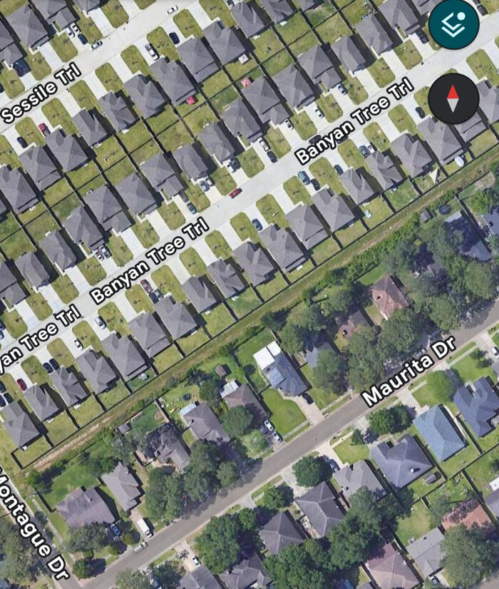 Aerial view of suburban neighborhood with uniform housing and streets
