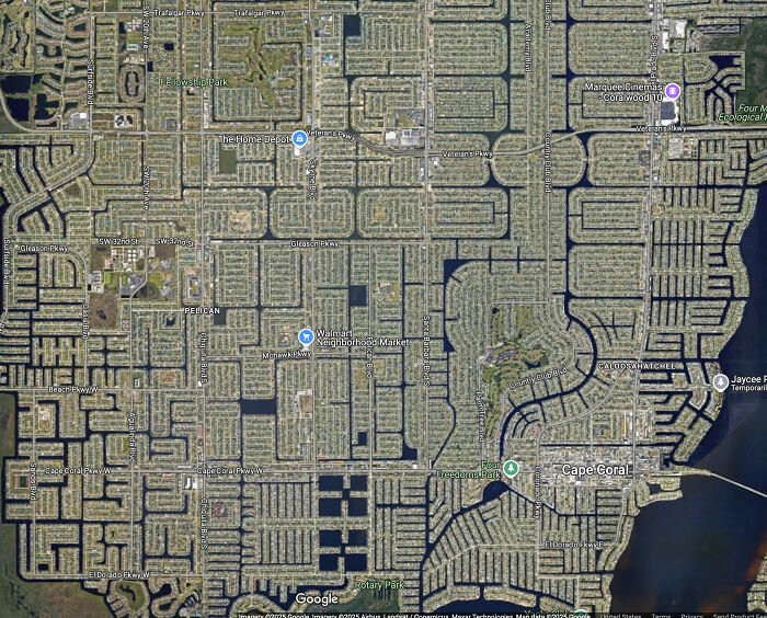 Aerial satellite image of Cape Coral focused on suburban street grid and canals