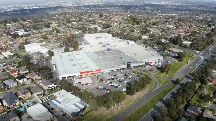 Suburban shopping center with parking lot and surrounding residential neighborhoods