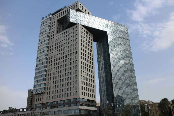 Modern glass and concrete office building with unique angular design