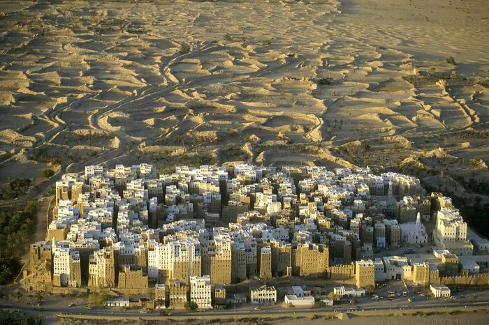 Dense cluster of traditional mud-brick buildings in a desert environment