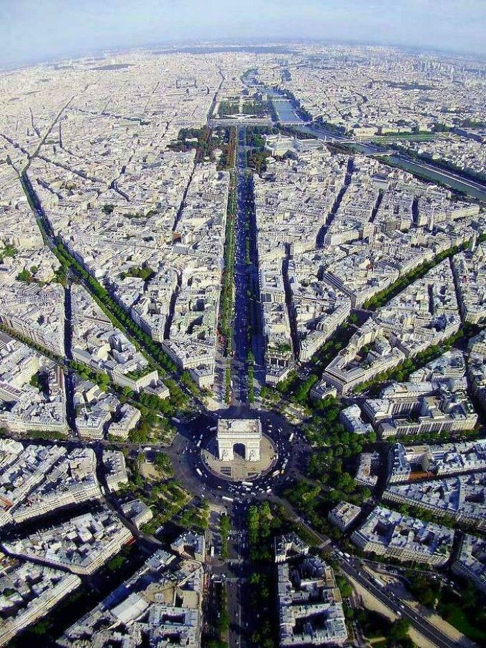 Aerial view of Paris with the Arc de Triomphe and surrounding urban streets