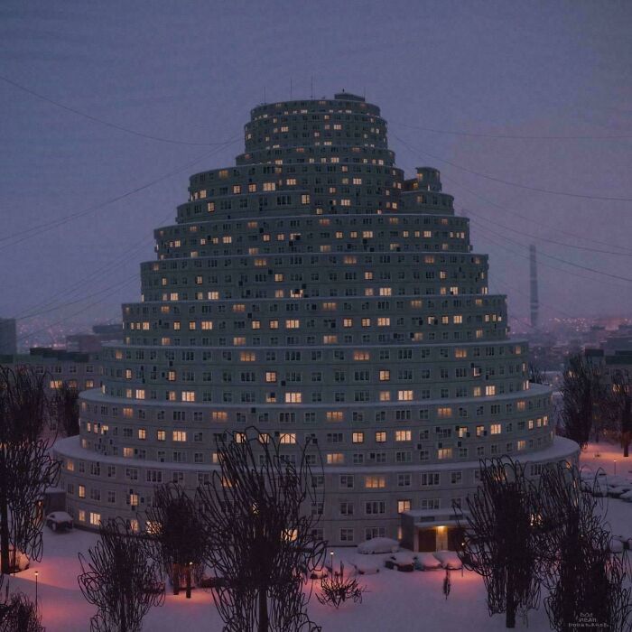 Nighttime view of a pyramid-shaped apartment building with many lights on