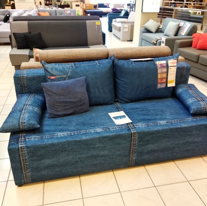 A denim-clad couch with matching pillows, showcasing a creative design for interior designers seeking stylish couches.