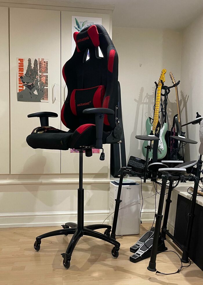 Gaming chair floating above ground next to musical instruments