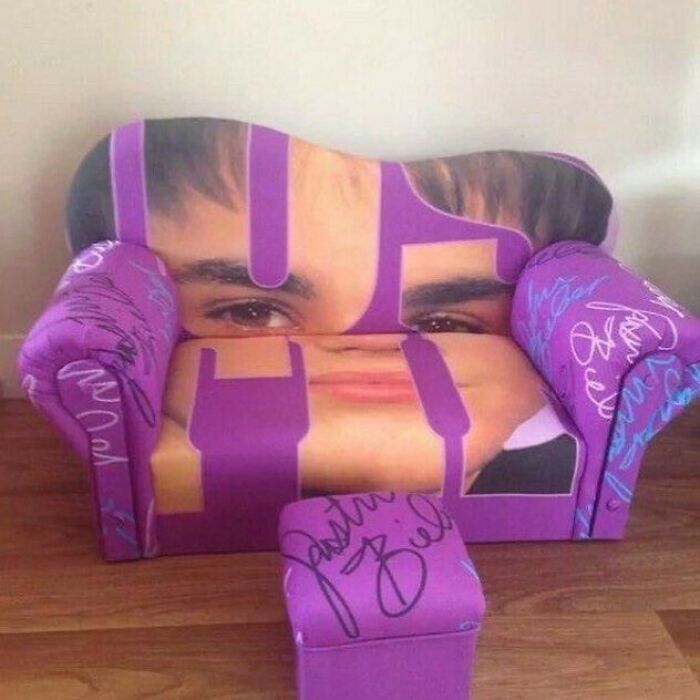 A vibrant purple couch featuring an image of Justin Bieber, a playful design for an interior designer.