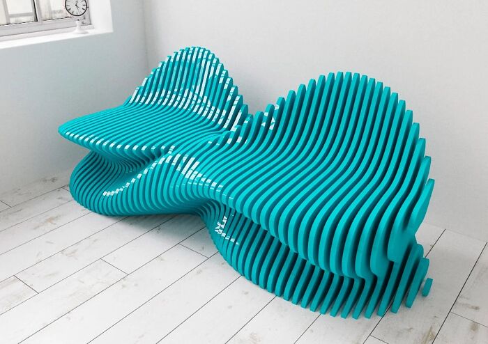 Modern, wavy turquoise couch made of layered slats, a bold statement for interior designers.
