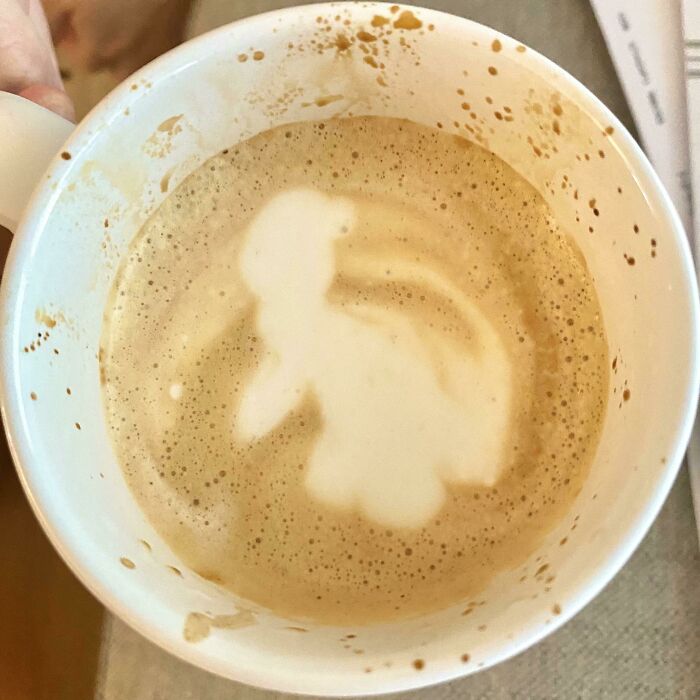 Cringe coffee fail with latte art resembling an unrecognizable figure