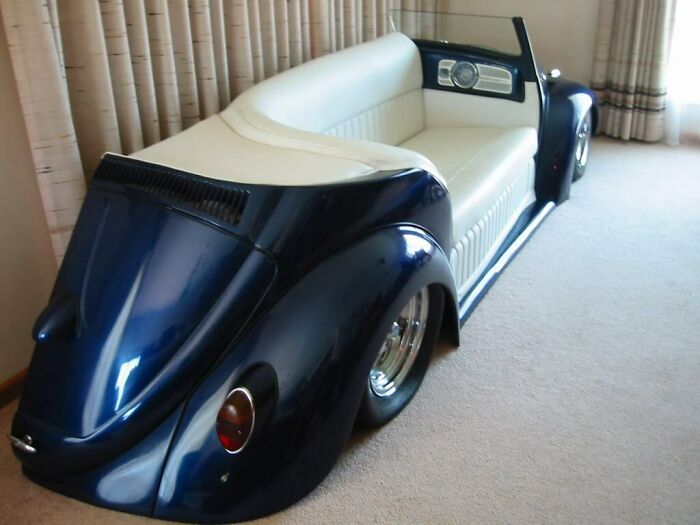 Custom couch designed like the back of a classic car, a striking piece for interior designers.