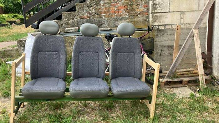 Three grey car seats repurposed as couches in a backyard, a quirky interior designer idea.