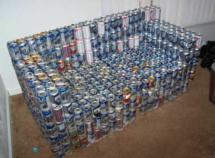 A couch creatively constructed from hundreds of aluminum cans, an unusual and eye-catching piece for interior designers exploring couches.