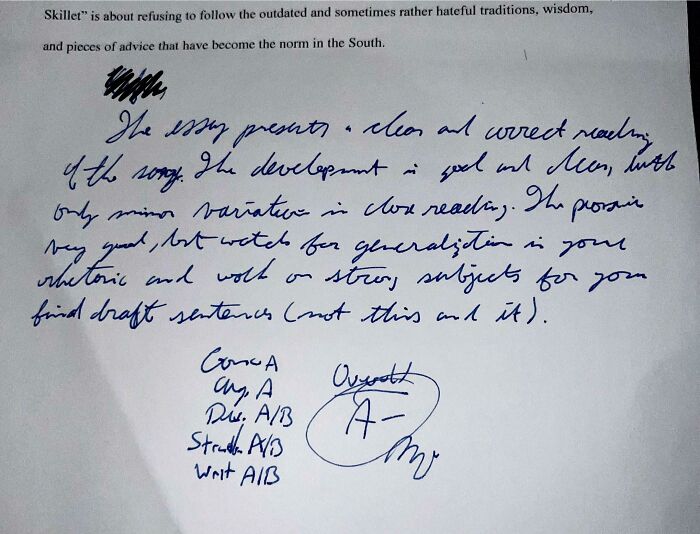 Paper with a teacher's handwritten comments and an A- grade, reflecting a student's experience with a teacher.