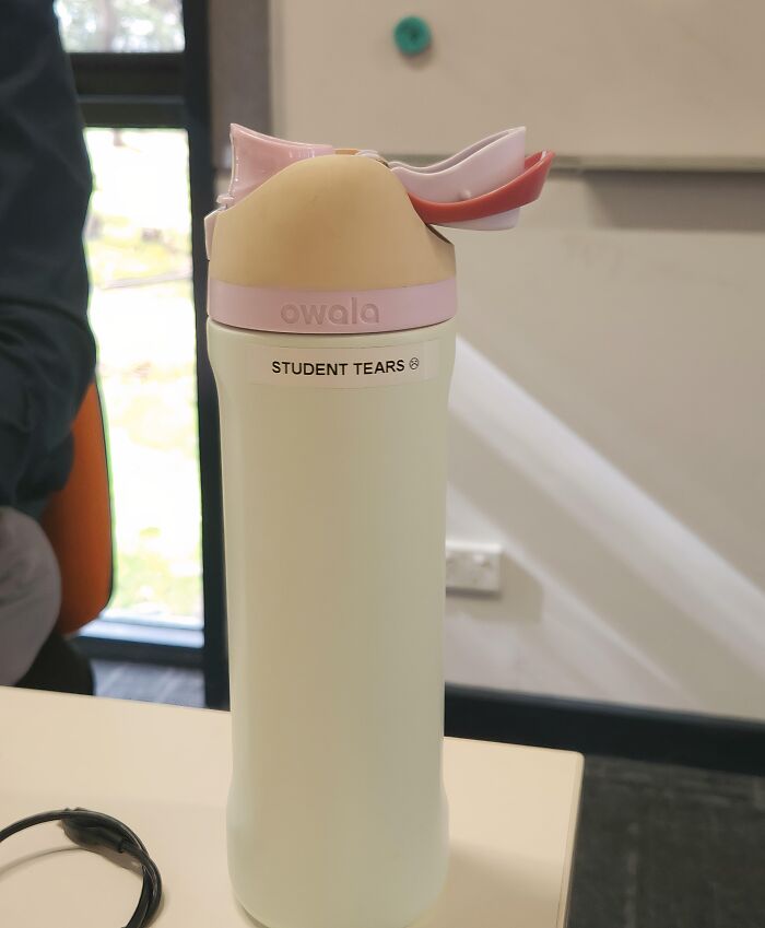 An Owala water bottle with a sticker that says STUDENT TEARS. Some teachers can be toxic and annoying.