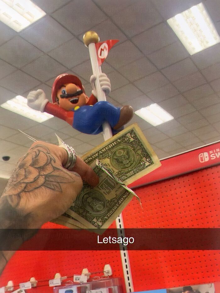 Person holding dollar bills near Mario figurine in store meme