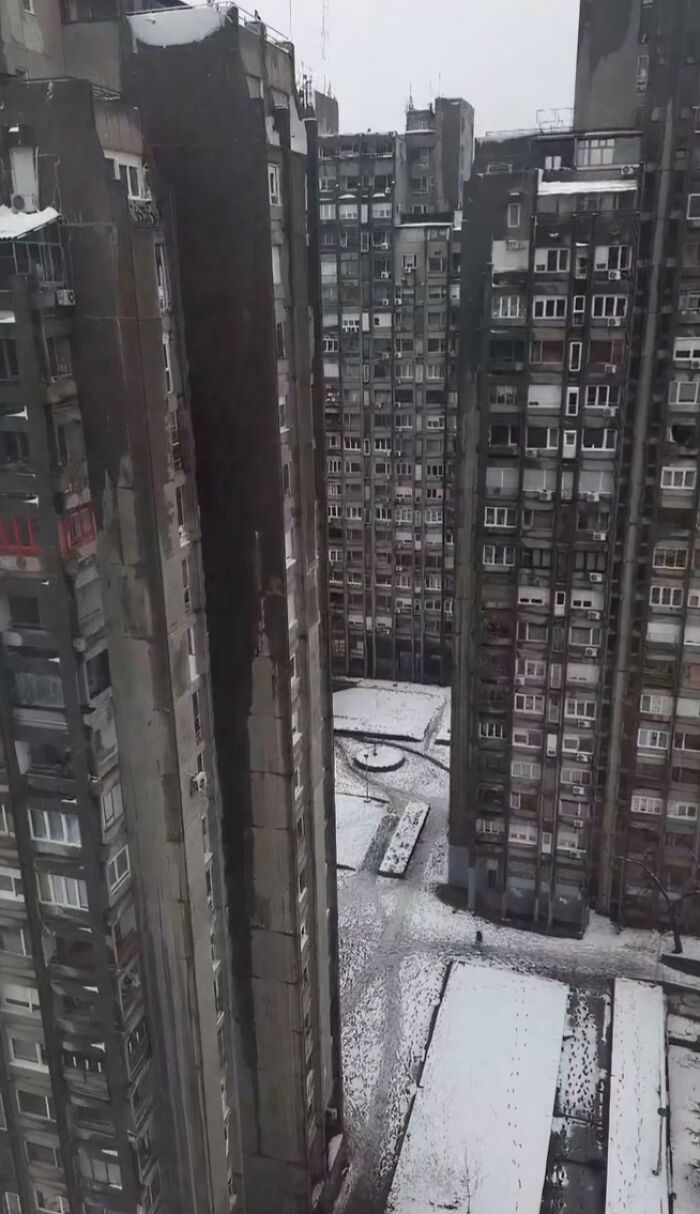 Snow-covered urban hell residential towers with narrow courtyard