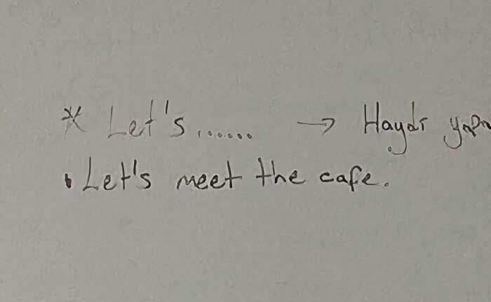A whiteboard with the handwritten phrase Let's meet the cafe, an example of a teacher's lesson that may be annoying.