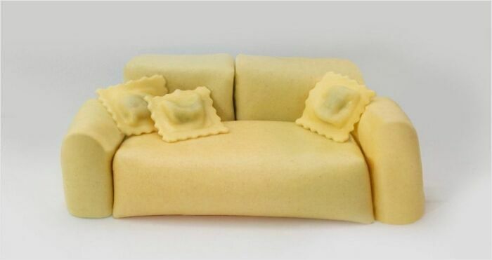 A miniature couch made entirely of pasta, with ravioli as cushions, a playful concept for an interior designer.