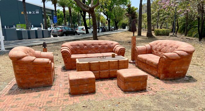 Outdoor seating area featuring a unique couch and chairs crafted from bricks, perfect for interior design.