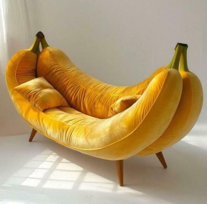A bright yellow couch shaped like a giant banana, complete with brown stems, a quirky choice for an interior designer.