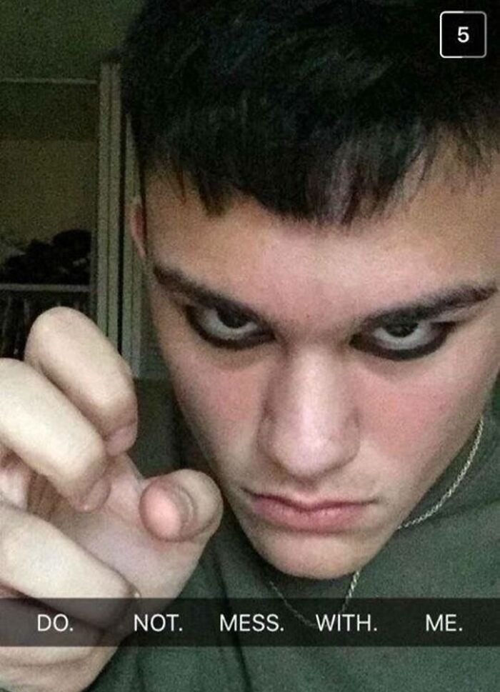 Young man acting tough with intense gaze and caption do not mess with me