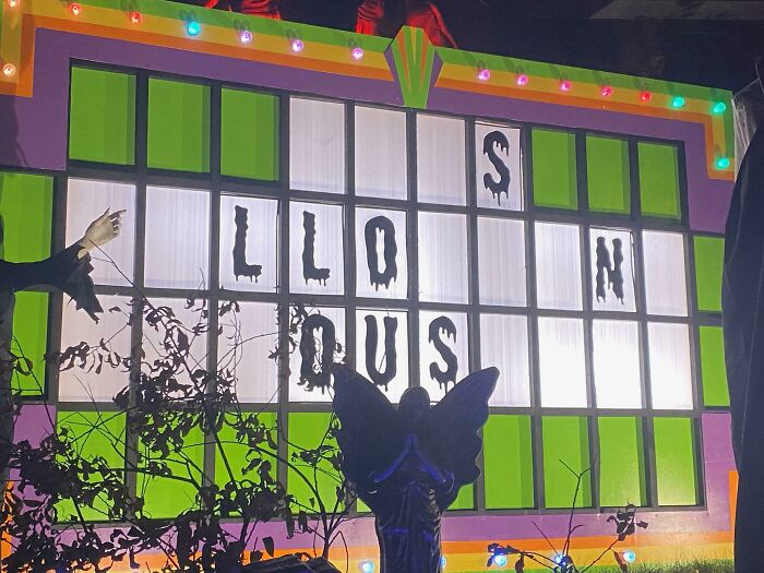 A vibrant image of a decorative wall with large letters, a fun brain puzzle that spells out a word.