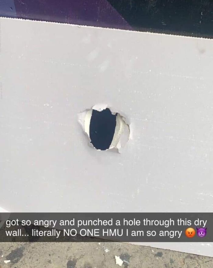 Hole punched in drywall with angry caption showing frustration