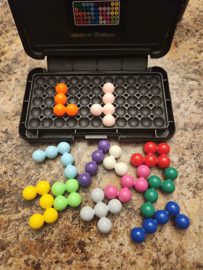 A colorful brain puzzle game with various shaped pieces, designed to humble confident people.