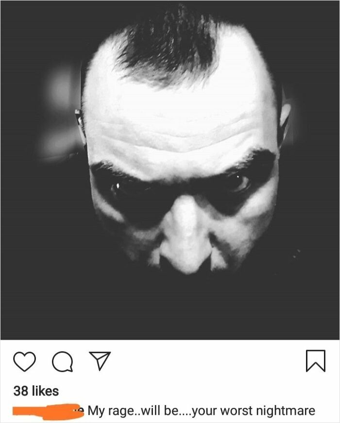 Black and white photo of a man with intense glare acting tough and aggressive