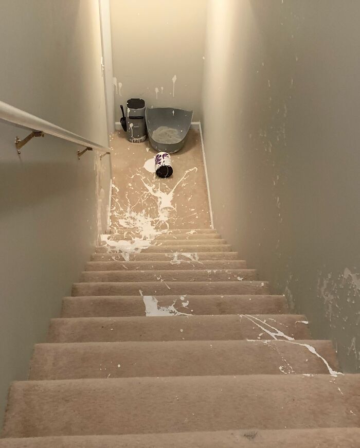 Paint can spilled on stairs with splattered carpet and walls in fail