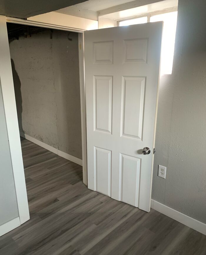 Basement room with a white door blocking access in a funny fail