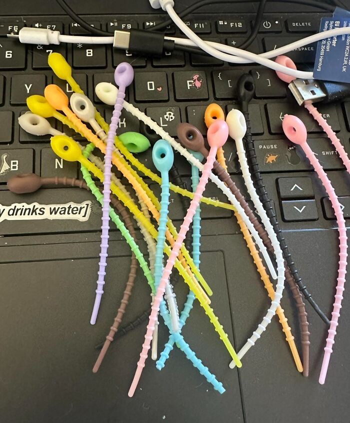 Colorful silicone cable ties tangled mess on black keyboard
