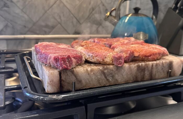 Steak cooking on a hot stone grill for grilling dads