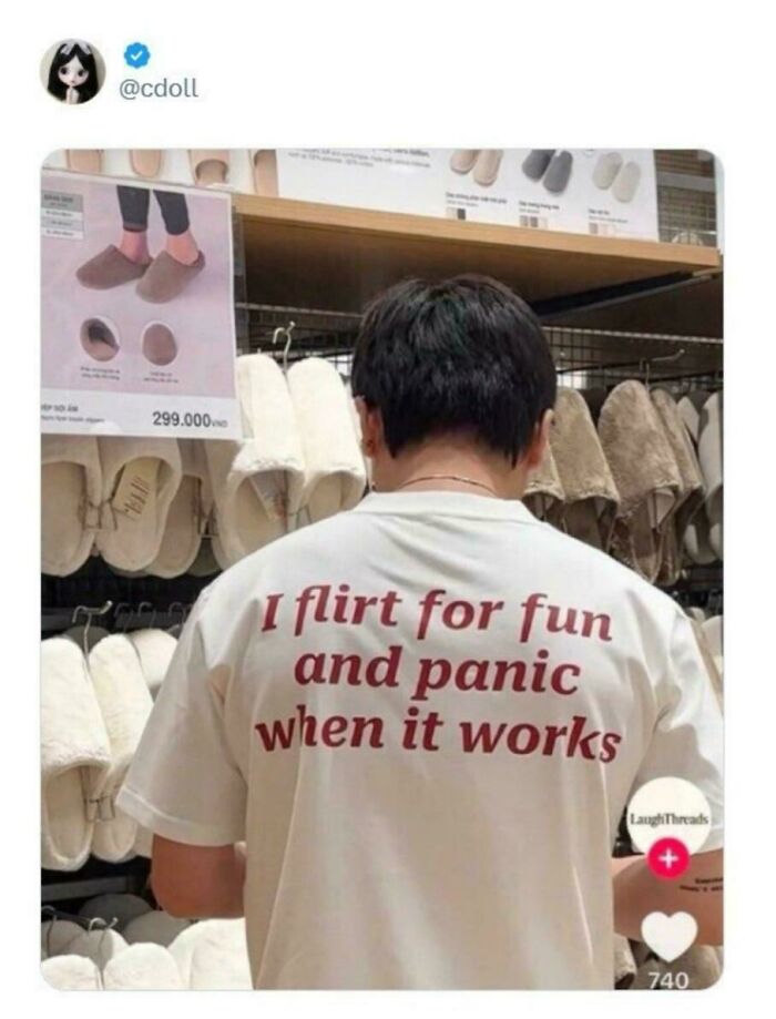 A person wearing a white shirt with a funny sentence, standing in an aisle with slippers. Unpredictable sentences often feature humor.