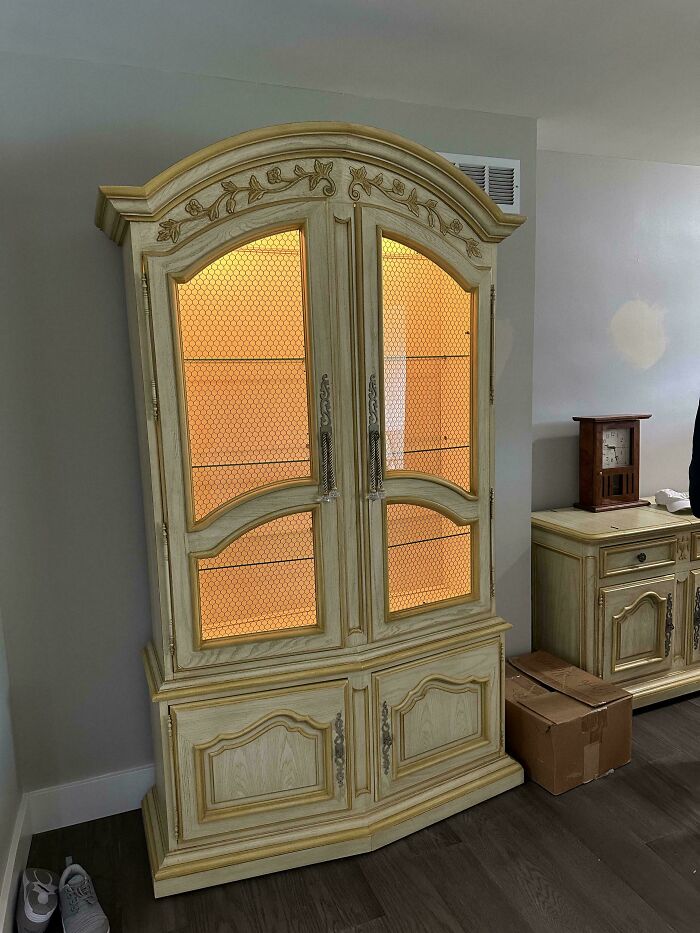 An elegant lighted display cabinet with intricate floral detailing, a great piece for any home decor project.
