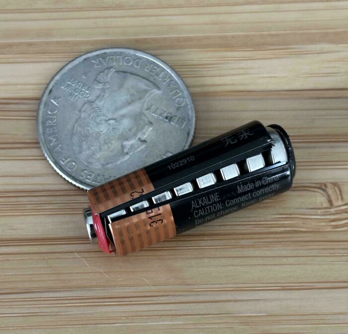 Mildly interesting picture of a miniature battery next to a US quarter, highlighting its small size.