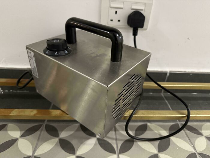 A portable ozone generator plugged into a wall socket, potentially a dangerous thing people did unnecessarily.
