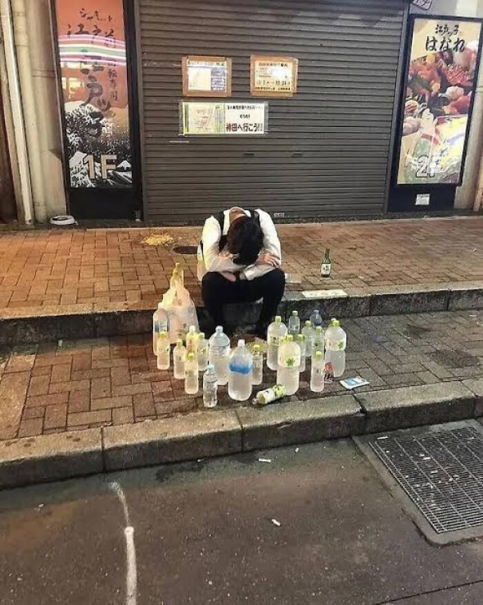 A man sits on a curb surrounded by plastic bottles, an interesting pic for a 5-minute brain boost.